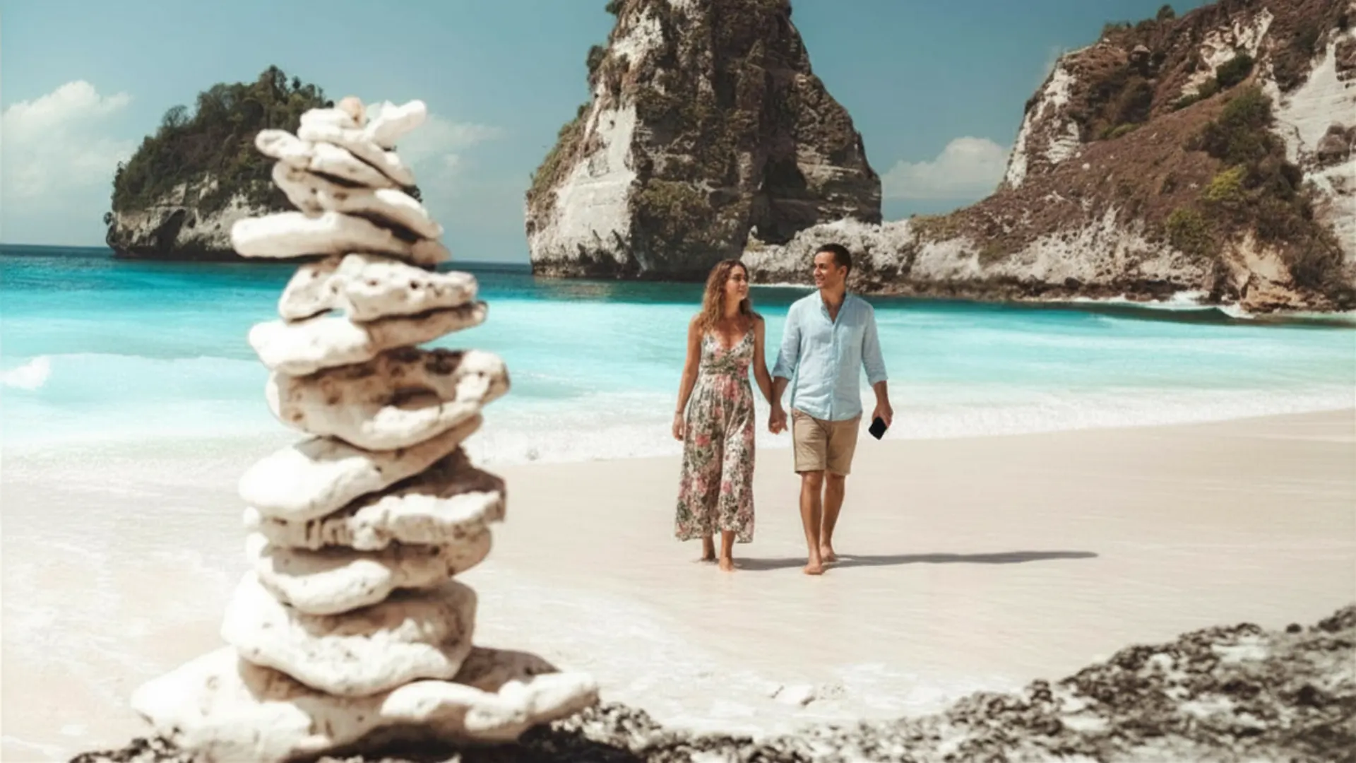 Diamond Beach Nusa Penida 2 Couple strolling along the pristine white shoreline at Diamond Beach Nusa Penida